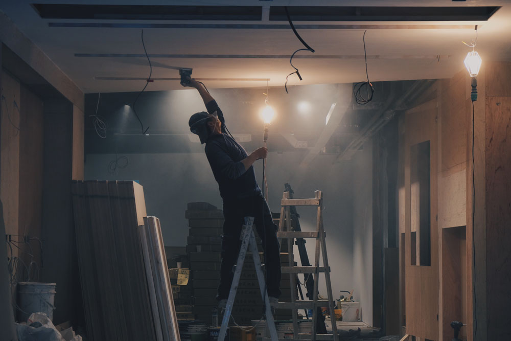 Plaster plastering a ceiling